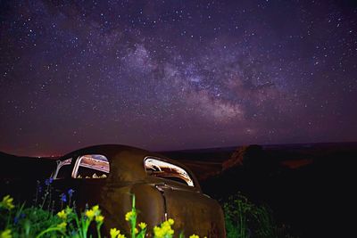 Scenic view of field against star field at night