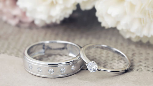 Close-up of wedding rings on table