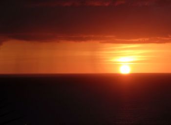 Scenic view of sea against romantic sky at sunset