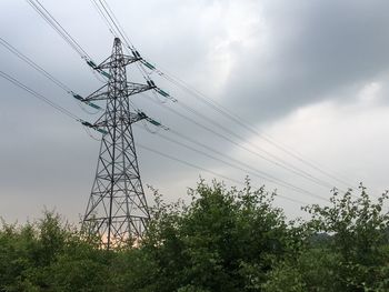 Low angle view of electricity pylon against sky