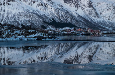 Scenic view of frozen sea against snowcapped mountain