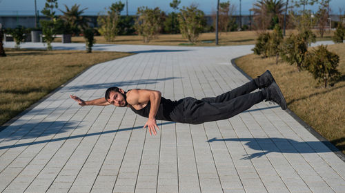 Low section of woman exercising on field