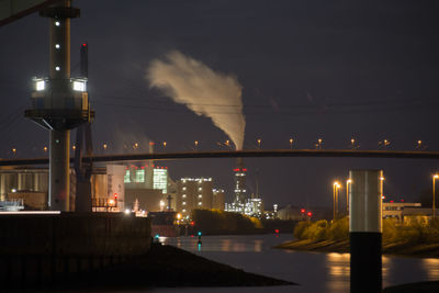 Illuminated city against sky at night