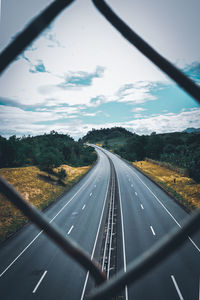 Road seen through windshield of car