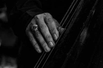 Close-up of hands playing string instrument