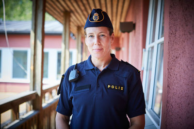 Portrait of policewoman standing in balcony at police station