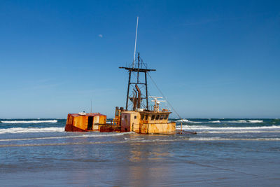 Sailboat on sea against clear sky