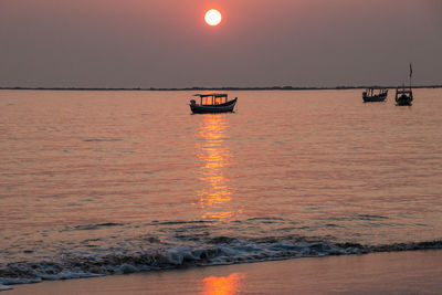 Scenic view of sea against orange sky