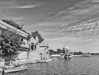 Scenic view of lake by building against sky