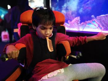 Rear view of cute girl sitting on stage