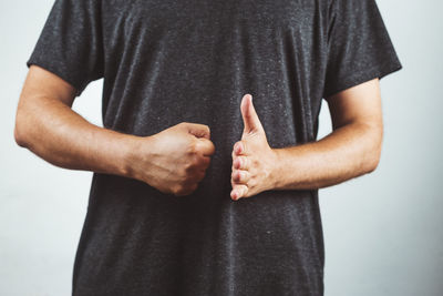 Midsection of man standing against white background