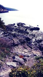 High angle view of rocks on beach against sky