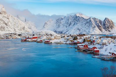 Aerial view of town by sea against mountains