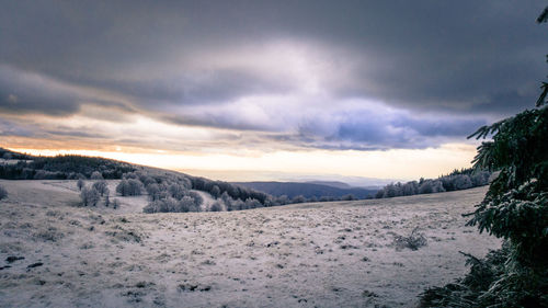 Scenic view of landscape against sky during winter