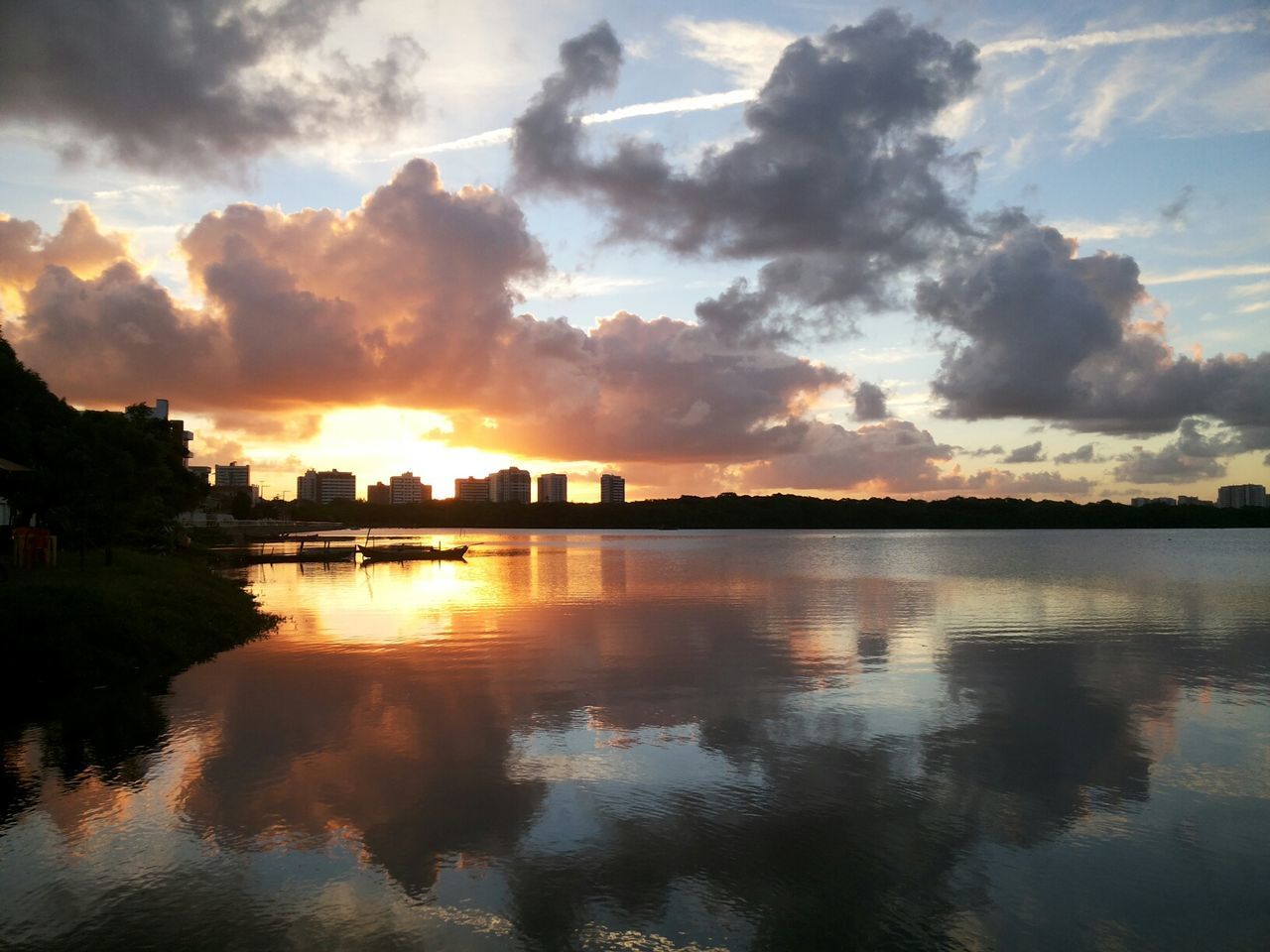 sunset, water, reflection, sky, waterfront, sun, cloud - sky, lake, orange color, scenics, tranquility, beauty in nature, built structure, architecture, tranquil scene, river, silhouette, nature, sunlight, cloud