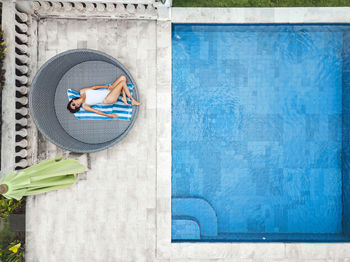 Aerial view of attractive woman near the pool at resort