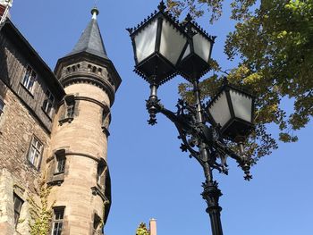 Low angle view of street light against building