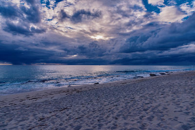 Scenic view of beach against sky during sunset