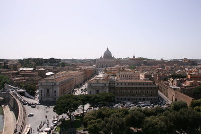 Aerial view of buildings in city against clear sky