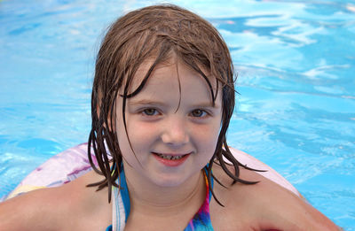 Portrait of smiling girl swimming in pool