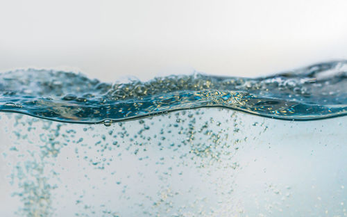 Close-up of water drops against blue background