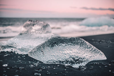 Scenic view of ice block against sky during sunset