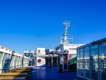 Ship at harbor against clear blue sky