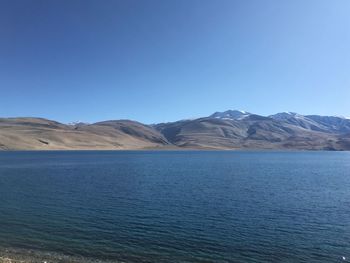 Scenic view of mountains against clear blue sky