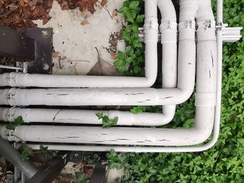 High angle view of pipe against wall in yard