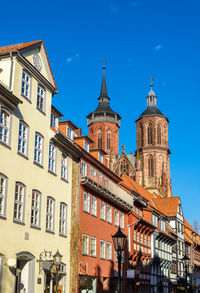 Low angle view of buildings against blue sky