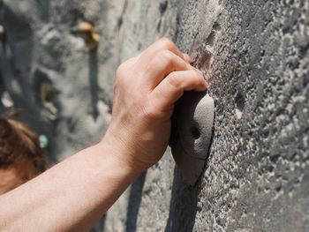 Cropped image of hand on climbing wall