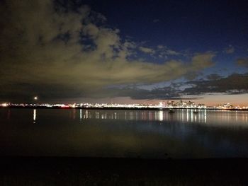 Scenic view of lake against sky at night