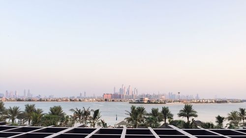 View of city buildings against clear sky