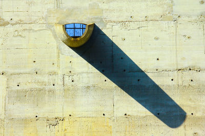 Close-up of arrow sign on wall