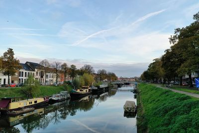 Canal amidst buildings against sky