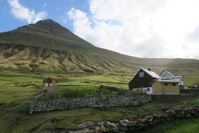 Scenic view of landscape and houses against sky