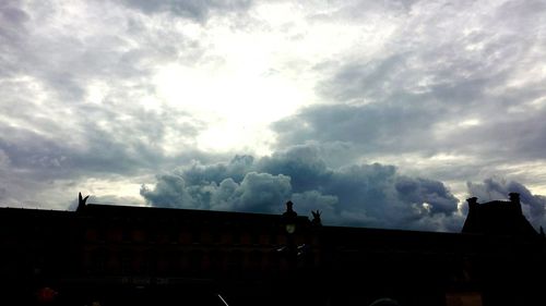 Low angle view of building against cloudy sky