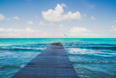 Pier over sea against sky