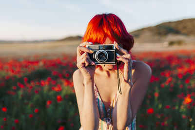 Woman photographing during sunset