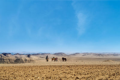 Unidentified people in desert of great giza,cairo in egypt