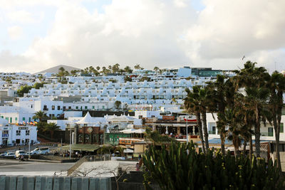 Houses by sea against sky