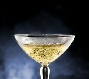 Close-up of beer glass against black background