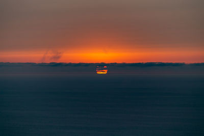 Scenic view of sea against romantic sky at sunset