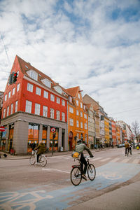 Bicycles parked on street against buildings in city