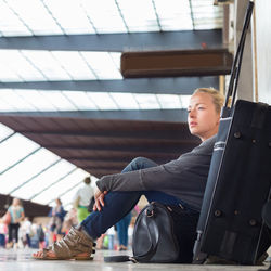 Man looking away while sitting in airport
