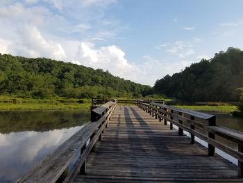 Pier over lake against sky