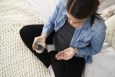 Pregnant woman eating medicine