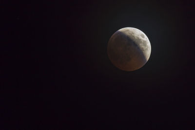 Low angle view of moon against sky at night
