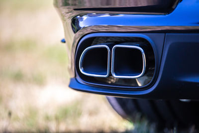 Sportive mufflers, close up on double car exhaust pipe. supercar rear view.