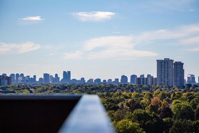 View of cityscape against cloudy sky